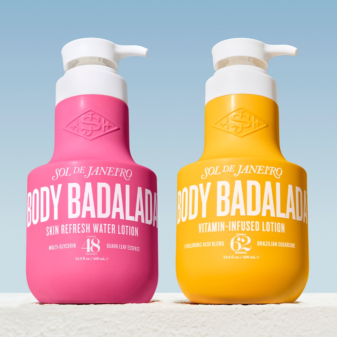 Zwei Flaschen Sol de Janeiro Body Badalada Lotion, eine in Pink für eine erfrischende Hautlotion und eine in Gelb für eine mit Vitaminen angereicherte Lotion.