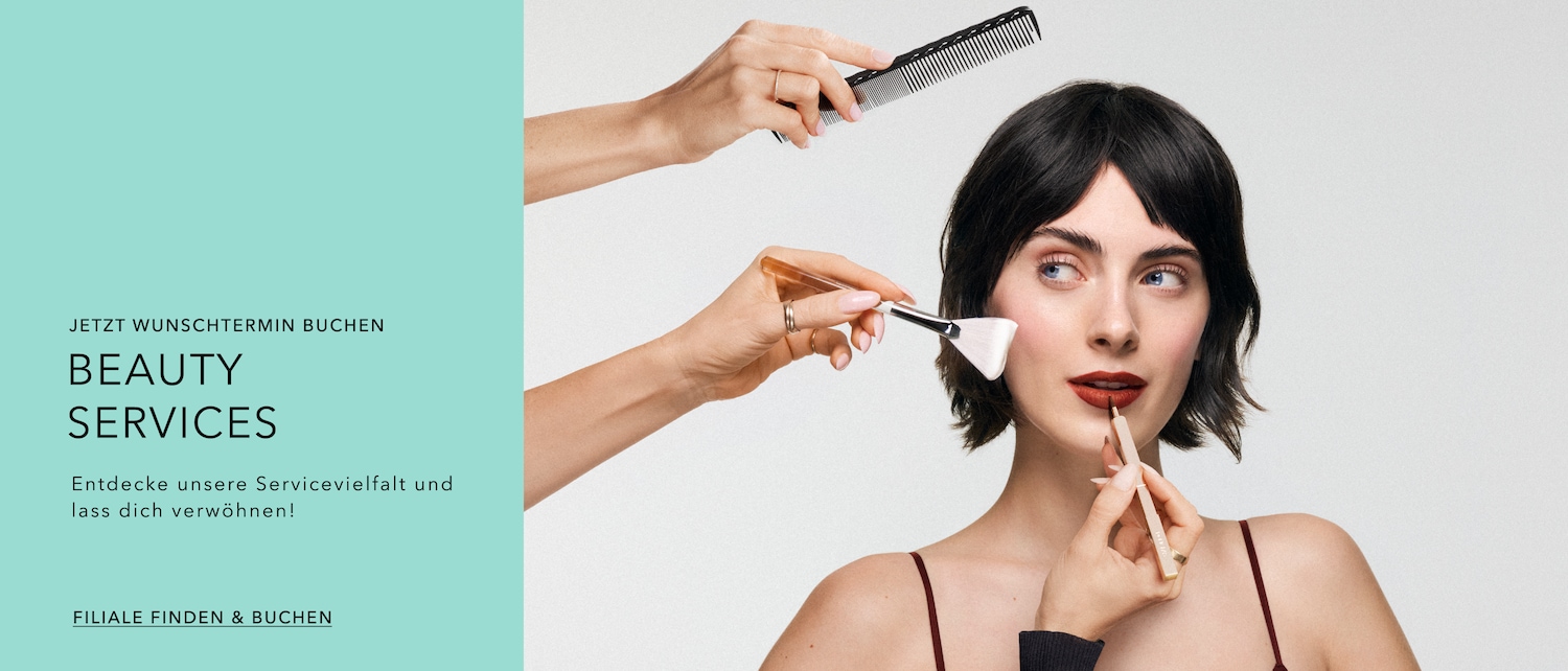 A woman with fair skin and dark red lipstick is getting her makeup done with a brush, while a comb is held above her head, promoting beauty services.
