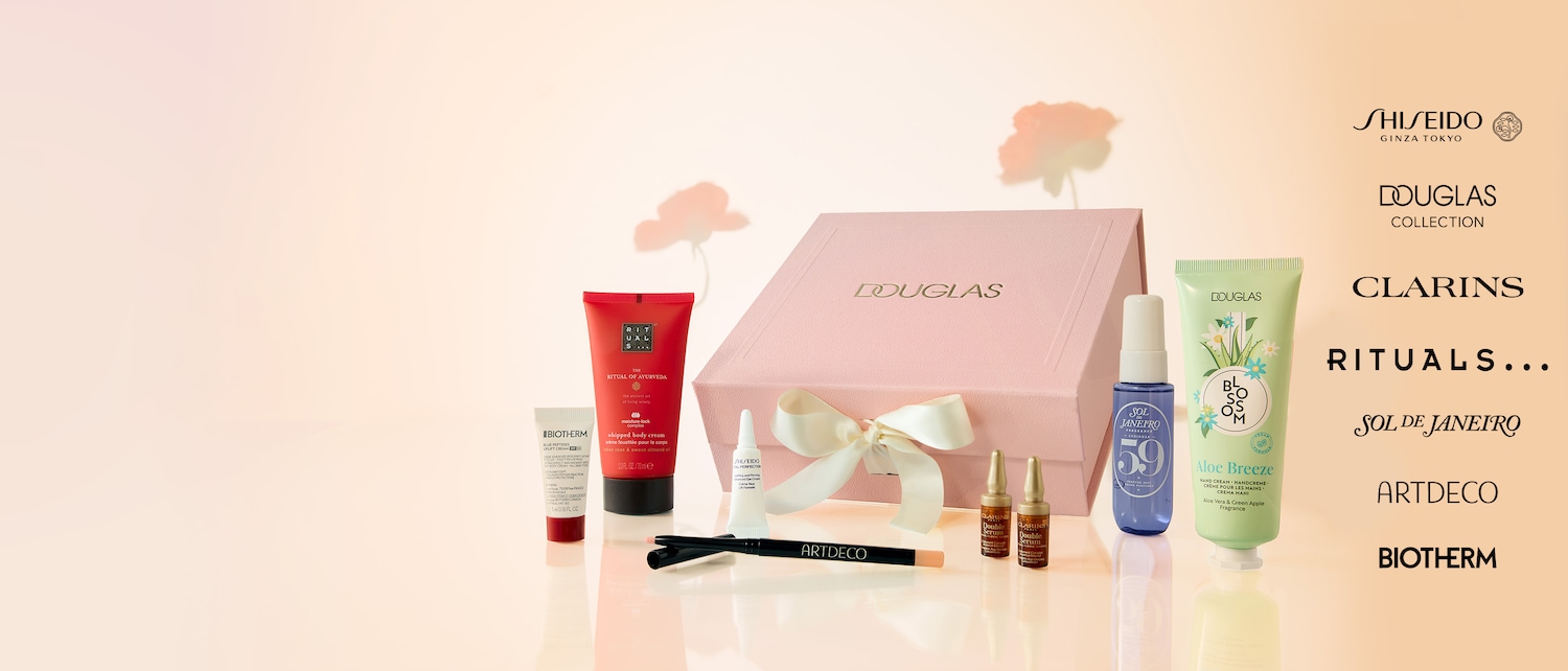 Entdecken Sie eine Auswahl an Schönheitsprodukten von Marken wie Rituals, Biotherm und Artdeco, präsentiert in einer rosa Douglas-Geschenkbox mit Schleife.