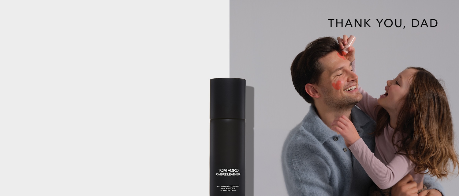 A black Tom Ford Ombré Leather all-over body spray stands next to a smiling dad with heart-shaped blush on his face, applied by his daughter, with the text "Thank You, Dad."